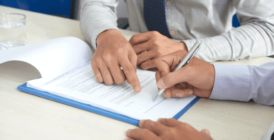 Picture of someone signing a contract